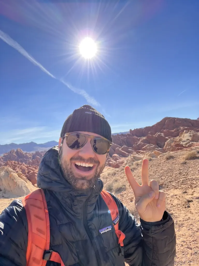 Clifton outdoors among red rocks under a blue sky